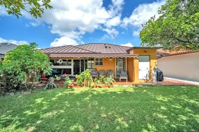 a yellow house with a yard at Lime Haus lime - Your Family Stay in Miami Awaits in Tamiami