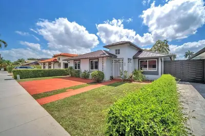 a white house with a yard at Lime Haus lime - Your Family Stay in Miami Awaits in Tamiami