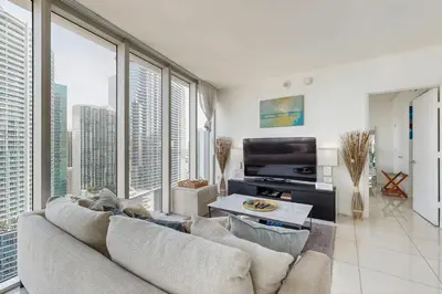 a living room with a couch and large windows at Tony Ultimate Experience Miami in Miami