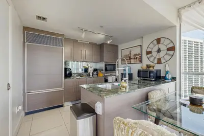 a kitchen with a counter with a sink and a window at Tony Ultimate Experience Miami in Miami