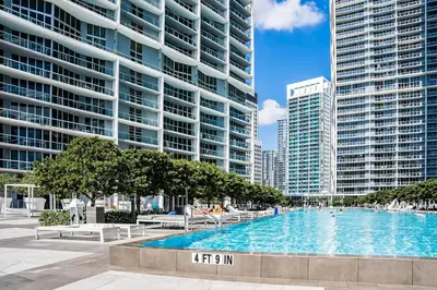 a large swimming pool in a city with tall buildings at Tony Ultimate Experience Miami in Miami