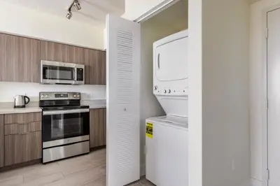 a kitchen with a refrigerator and a microwave at Blueground Riverside pool AC nr parks MIA-144 in Miami