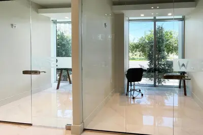 an open glass door in an office with a desk at Blueground Riverside pool AC nr parks MIA-144 in Miami