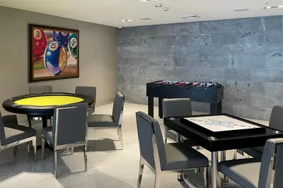 a dining room with two tables and a game table at Blueground Riverside pool AC nr parks MIA-144 in Miami
