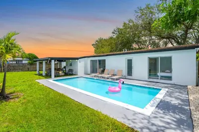 a swimming pool with a pink rubber duck in a backyard at Private Pool Home & Arcade game & Mini Basketball in Hollywood