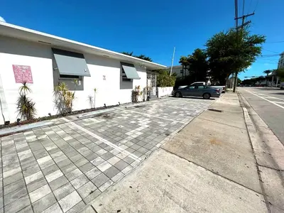 a car parked in a parking lot next to a building at Charming Miami Studio in Prime Location in Miami