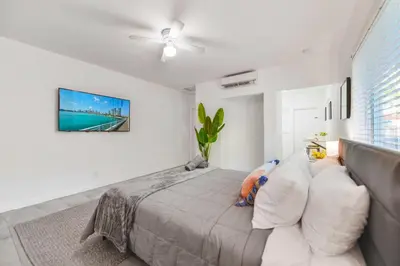 a bedroom with a bed and a couch at Charming Miami Studio in Prime Location in Miami