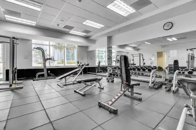 a gym with a lot of treadmills and machines at City-View Retreat in Brickell 2BR and Free Parking in Miami