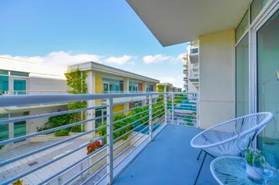 a balcony with a table and chairs on a building at Stylish Midtown Miami Condo - Pool & Prime Location in Miami
