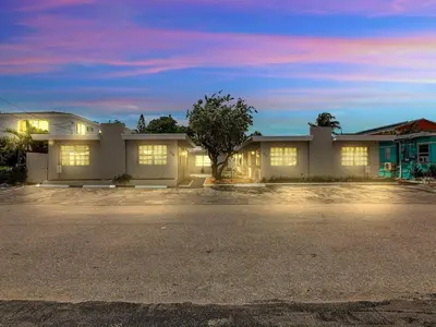 a house with lights on in a parking lot at Dania Beach 1BR | Views + WiFi + Parking in Dania Beach