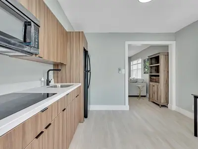 a kitchen with wooden cabinets and a sink at Dania Beach 1BR | Views + WiFi + Parking in Dania Beach