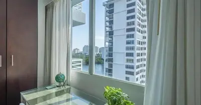 a large window with a view of a tall building at Modern Condo by the Beach, Water Taxi Stop, Prime Location! in Fort Lauderdale