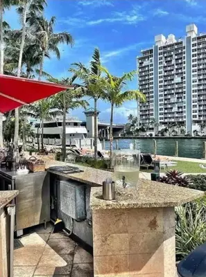a outdoor bar with a view of the ocean and buildings at Modern Condo by the Beach, Water Taxi Stop, Prime Location! in Fort Lauderdale