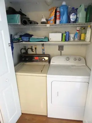 a small kitchen with a washing machine in it at South Beach and Collins, Parking included in Miami Beach