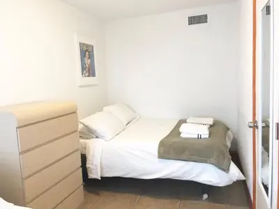 a small bedroom with a bed and a dresser at South Beach and Collins, Parking included in Miami Beach