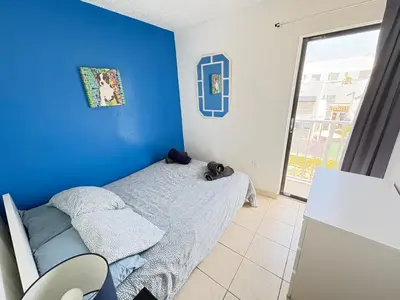 a bedroom with a bed with a blue wall at South Beach and Collins, Parking included in Miami Beach