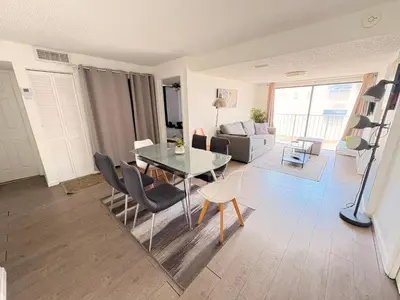 a living room with a glass table and chairs at South Beach and Collins, Parking included in Miami Beach