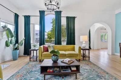 a living room with a yellow couch and a table at Havana Oh Na Na Unit A in Miami