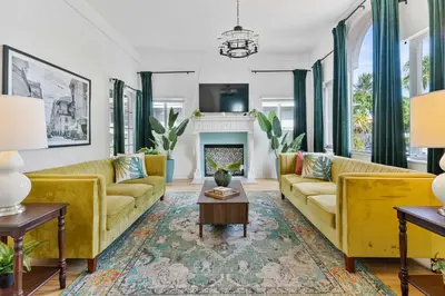 a living room with yellow couches and a fireplace at Havana Oh Na Na Unit A in Miami