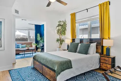 a bedroom with a bed and a living room at Havana Oh Na Na Unit A in Miami