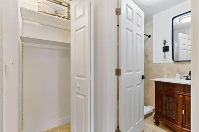 a bathroom with a white door and a sink at Havana Oh Na Na Unit A in Miami