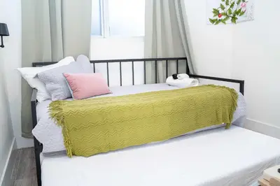 a bed with a yellow blanket and a stuffed animal on it at Havana Oh Na Na Unit C in Miami