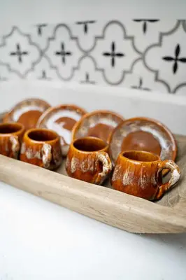 a wooden tray of cinnamon rolls on a table at Havana Oh Na Na Unit C in Miami