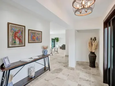a living room with a table and a vase at Villa Riverland in Fort Lauderdale