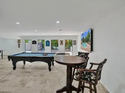 a room with a pool table and a ping pong ball at Villa Riverland in Fort Lauderdale
