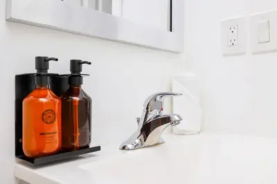 a bathroom with two bottles of soap and a sink at Alton Rd By At Mine Hospitality in Miami Beach