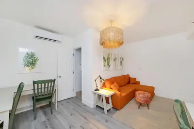 a living room with a couch and a table at Alton Rd By At Mine Hospitality in Miami Beach