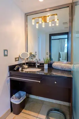 a bathroom with a sink and a large mirror at Penthouse with Private Rooftop in Miami Beach