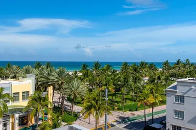 an aerial view of a resort with palm trees and the ocean at Penthouse with Private Rooftop in Miami Beach