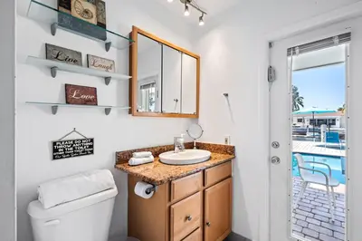 a bathroom with a sink and a mirror at Waterfront Oasis with Pool, Sunset Views and Dock in Fort Lauderdale