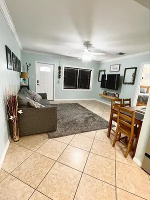 a living room with a couch and a table at Fort Lauderdale Florida Beach Vibe Hangout in Fort Lauderdale