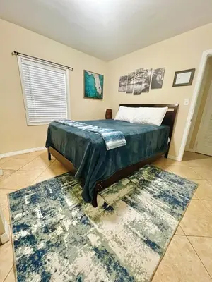 a bedroom with a bed and a rug at Fort Lauderdale Florida Beach Vibe Hangout in Fort Lauderdale