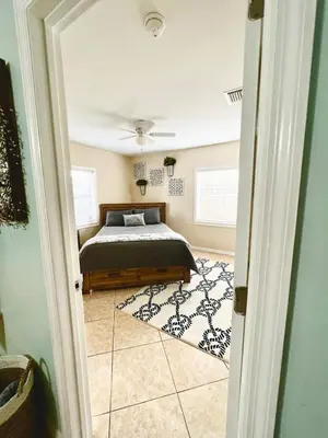 a bedroom with a bed and a rug at Fort Lauderdale Florida Beach Vibe Hangout in Fort Lauderdale