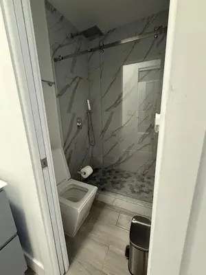 a bathroom with a white toilet and a shower at Modern and private studio in Miami