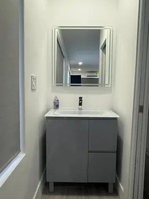 a bathroom with a sink and a mirror at Modern and private studio in Miami