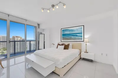 a white bedroom with a large bed and large windows at Luxury Unit 1 Bed W Residences Brickell in Miami