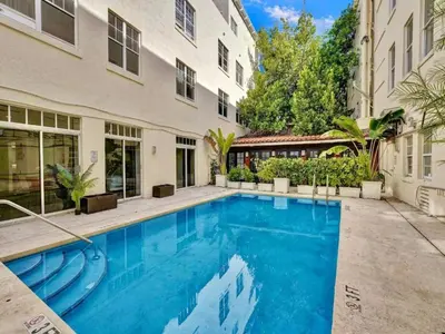 a swimming pool in front of a building at Pool and Jacuzzi. Walk to beach, South Point Pier in Miami Beach