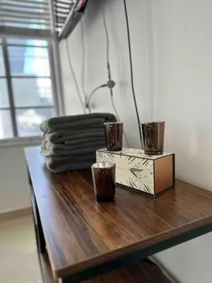 a table with two cups and a box on it at Right on the beach, Ocean Drive Secured Condo in Miami Beach