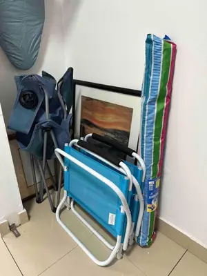 a luggage cart sitting next to a wall with a bag at Right on the beach, Ocean Drive Secured Condo in Miami Beach