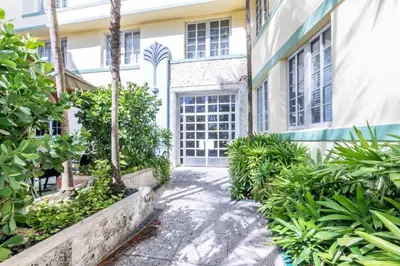 a courtyard of a building with trees and plants at Right on the beach, Ocean Drive Secured Condo in Miami Beach