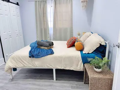 a bed with blankets and pillows in a bedroom at Center Miami Designer Home 3 BR sleeps 9 in Miami