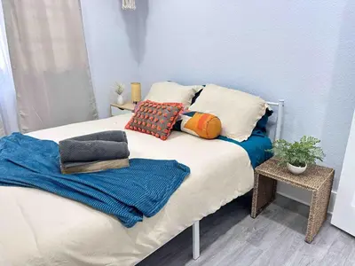a bed with pillows and blankets on top of it at Center Miami Designer Home 3 BR sleeps 9 in Miami