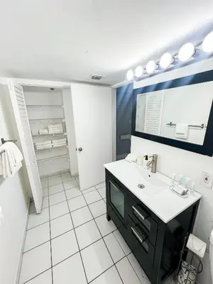 a bathroom with a sink and a mirror at Shine Suites Balcony Duplex 5 in Miami Beach