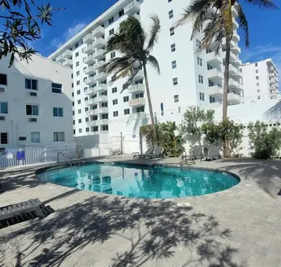 a swimming pool in front of a large building at South of Fifth Oceanfront condo with Beach Perks! in Miami Beach