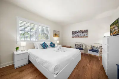 a white bedroom with a large bed and a window at Hollywood Beach Bliss Villa Sleeps 10 in Hollywood