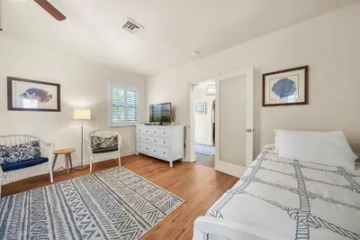 a bedroom with a bed and a dresser and a tv at Hollywood Beach Bliss Villa Sleeps 10 in Hollywood